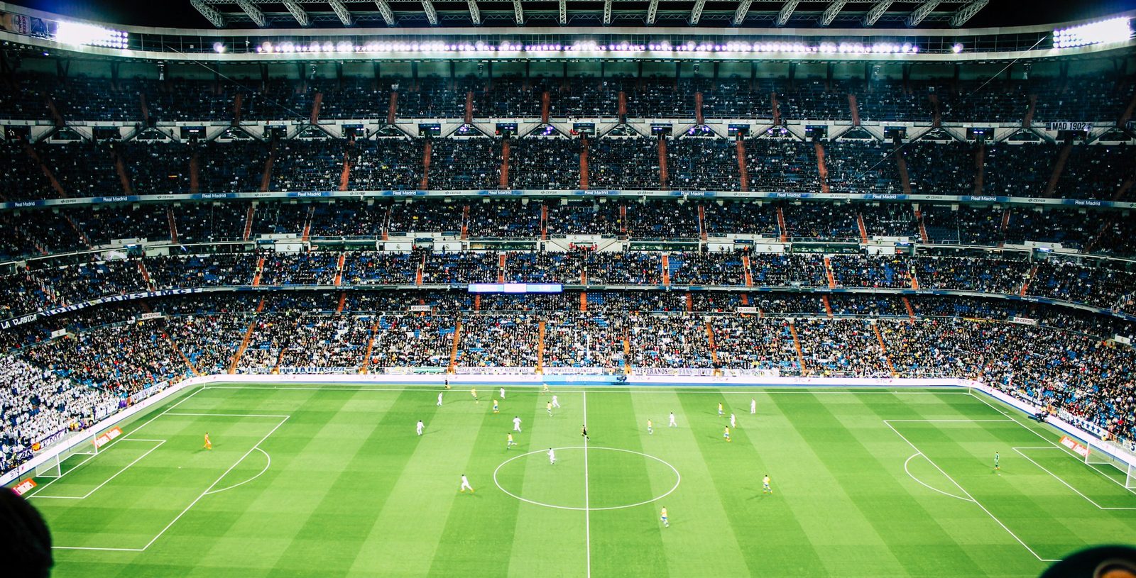 A packed football stadium under floodlights, streamed live on Sharo5